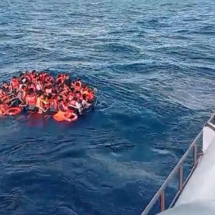 Survivors from a burning ferry floating on the water off Lombok Island on Aug 12, 2026.