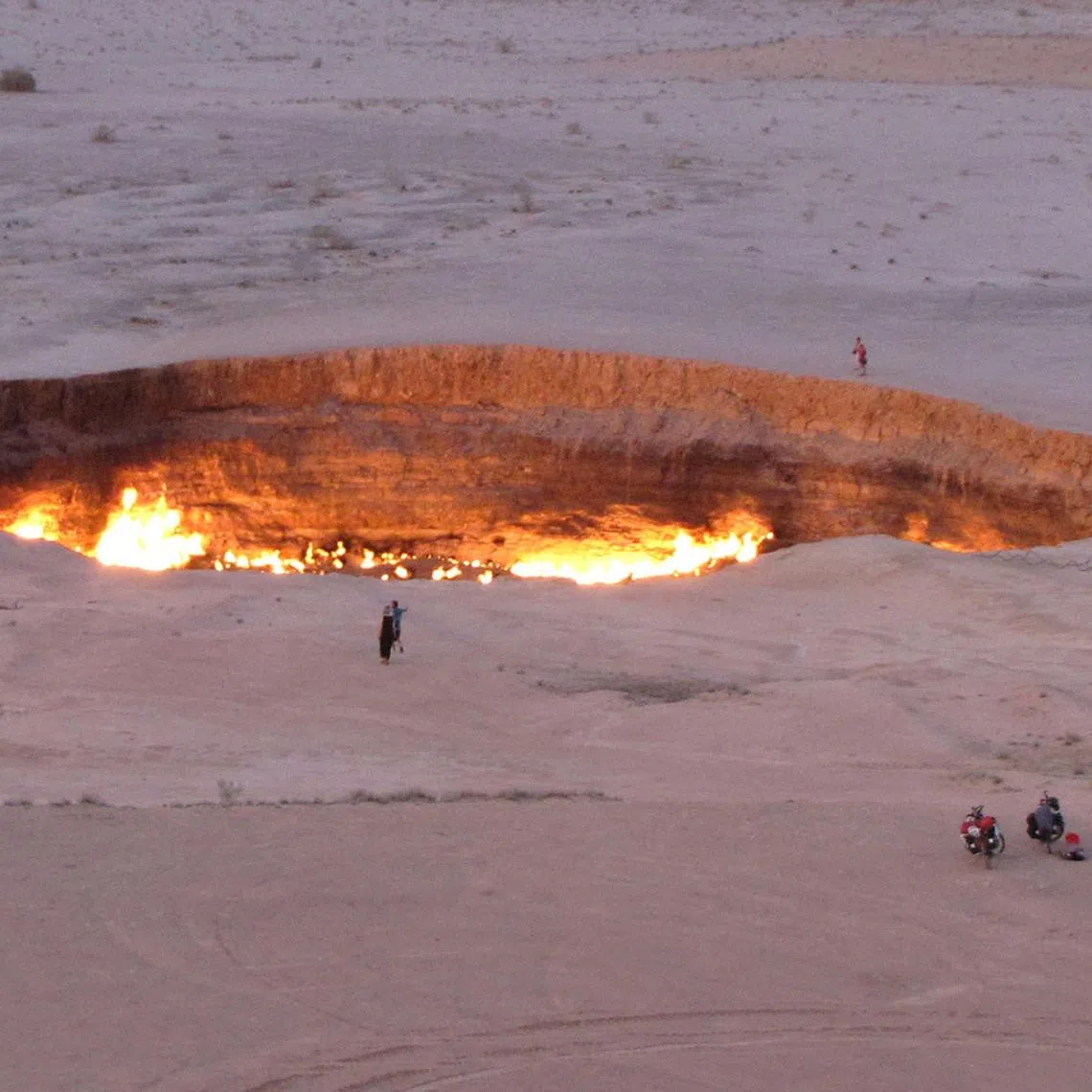 People visiting the "Gateway to Hell", a huge burning gas crater in the heart of Turkmenistan's Karakum desert.