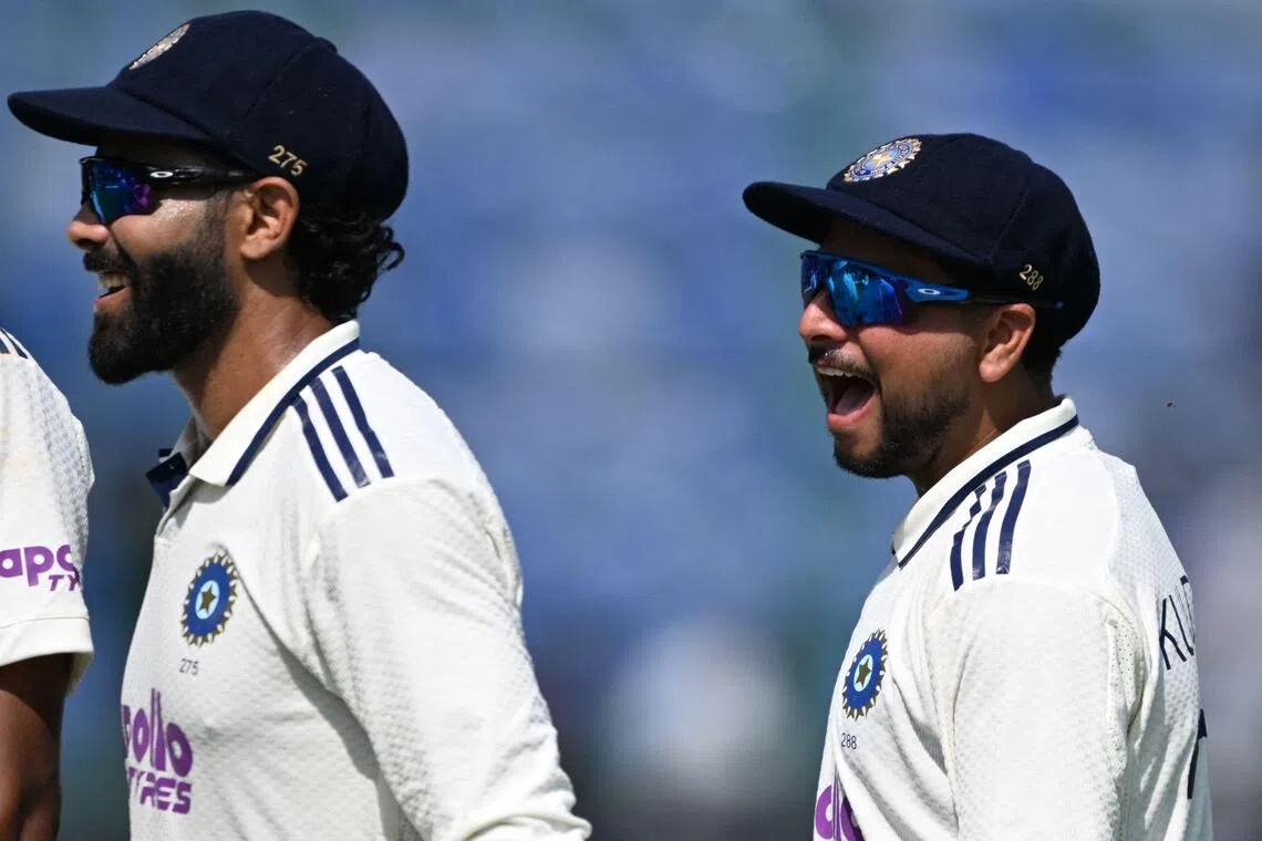 India's Kuldeep Yadav (right) and Ravindra Jadeja on the third day of the second cricket Test against West Indies at the Arun Jaitley Stadium in New Delhi on Oct 12, 2025. Yadav, with eight wickets, was named player of the match and Jadeja player of the tournament.