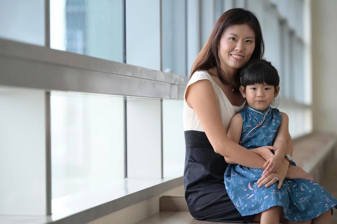  Ms Carolyn Koh made it a point to narrate her daily activities to her daughter, Ariel, to help her pick up language after her cochlear implants at 13 months old. ST PHOTO: NG SOR LUAN