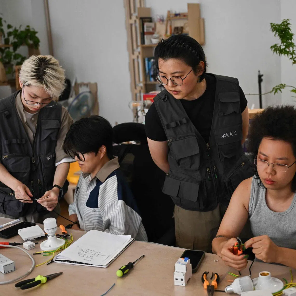 Instructors Wu Shuang (second from right) and Wang Risun (left) giving an electricity course to a group of women at the Mulan Build workshop in Hangzhou, China, on June 28.