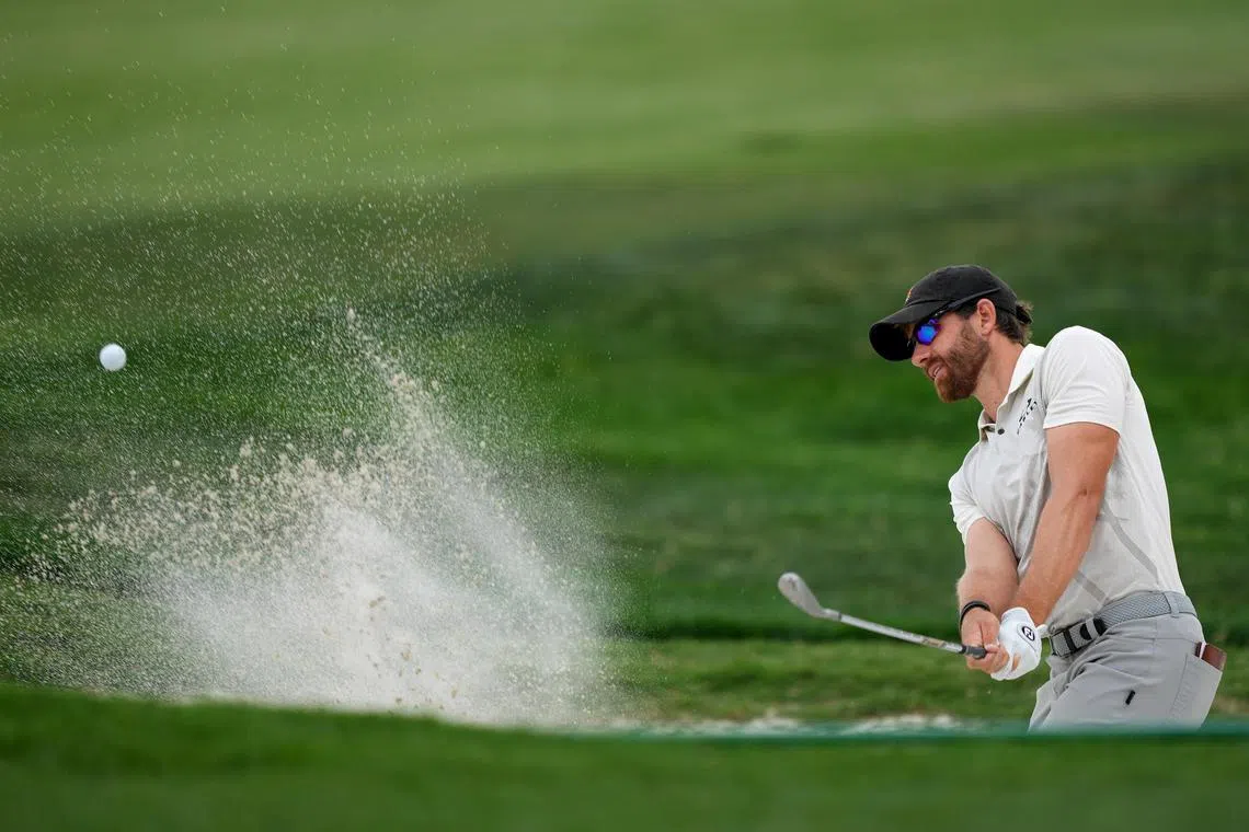 Patrick Rodgers of the United States playing his shot from the bunker on the 18th hole during the third round of the Valero Texas Open at TPC San Antonio on Saturday. He shot a one-under 71 to sit at 12-under 204 at the Oaks Course, good for a one-stroke lead. 