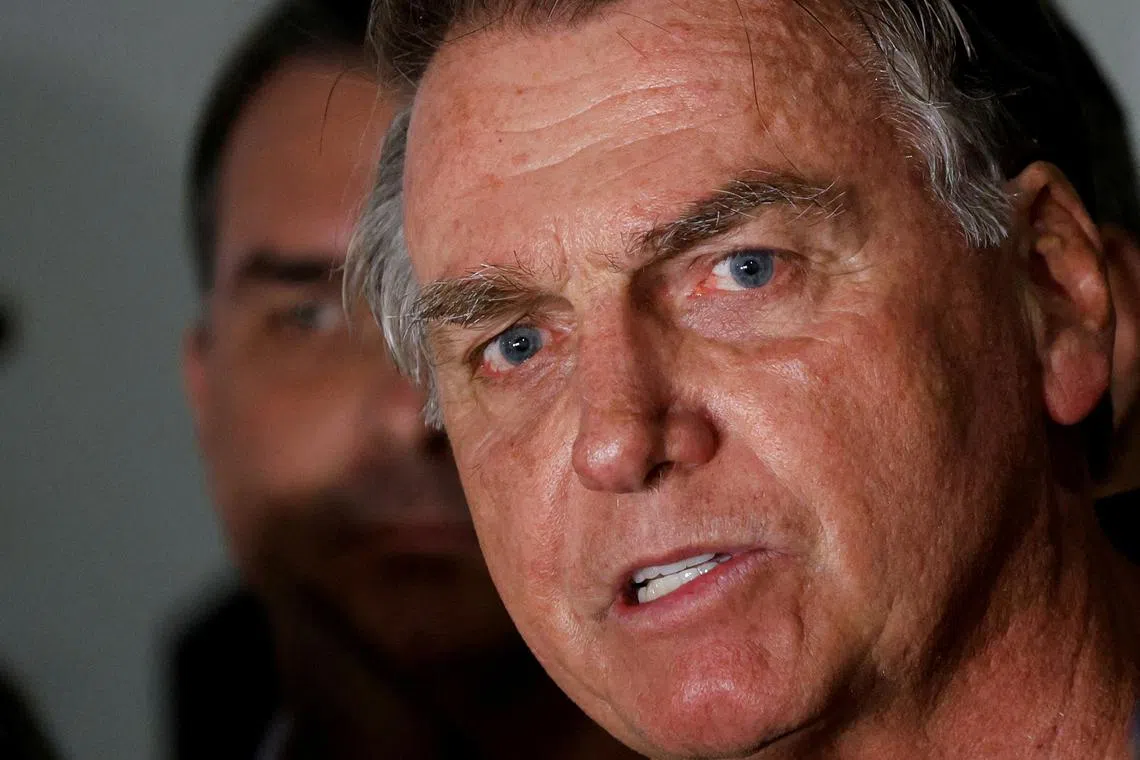 FILE PHOTO: Brazil's former President Jair Bolsonaro talks with media upon his arrival at Brasilia International Airport, in Brasilia, Brazil November 25, 2024. REUTERS/Adriano Machado