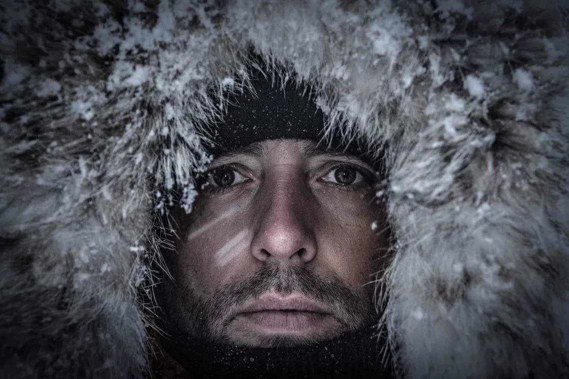 Five times freediving World Champion France's Arthur Guerin-Boeri poses on the Spildra Island northern Arctic Circle, along the shore to spot Orcas (Killer Whales), on Jan 24, 2023. 