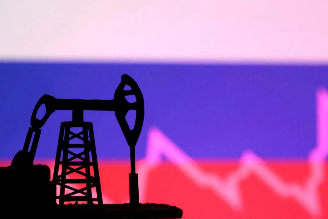 FILE PHOTO: Russian flag with stock graph and an oil pump jack miniature model are seen in this illustration taken October 9, 2023. REUTERS/Dado Ruvic/Illustration/File photo