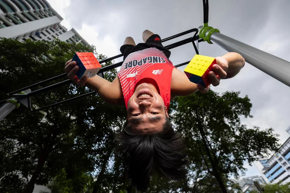 ST20251108_202569000368/dgtrack/Brian Teo/Deepanraj A C Ganesan/Profile of National sprinter Daryl Tan, 23, at the void deck of his home in Geylang Bahru on Nov 8, 2025. He has a passion for solving Rubik’s cubes and holds nine Guinness World Records for his speedcubing feats, including the fastest time to solve a 4×4×4 rubik's cube upside down in 37.25 seconds. ST PHOTO: BRIAN TEO