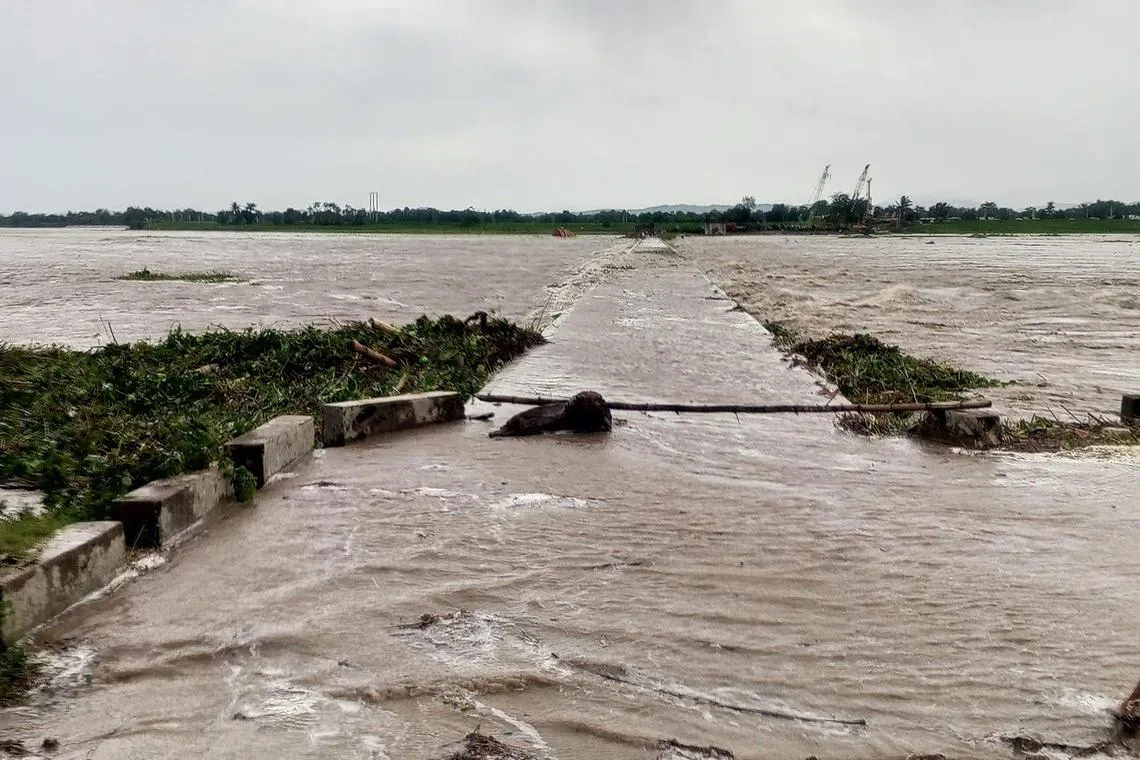 This handout photo taken on July 26, 2023 and received through the courtesy of the Facebook page of Cagayan provincial information office shows a flooded bridge in Tuao town, Cagayan province, after a river overflowed due to heavy rains brought about by Super Typhoon Doksuri. A super typhoon swept towards the northern Philippines, the country's weather agency said, triggering evacuation orders for coastal communities expected to bear the brunt of the powerful storm. (Photo by STRINGER / Cagayan provincial information office / AFP) / -----EDITORS NOTE --- RESTRICTED TO EDITORIAL USE - MANDATORY CREDIT "AFP PHOTO / CAGAYAN PROVINCIAL INFORMATION OFFICE " - NO MARKETING - NO ADVERTISING CAMPAIGNS - DISTRIBUTED AS A SERVICE TO CLIENTS