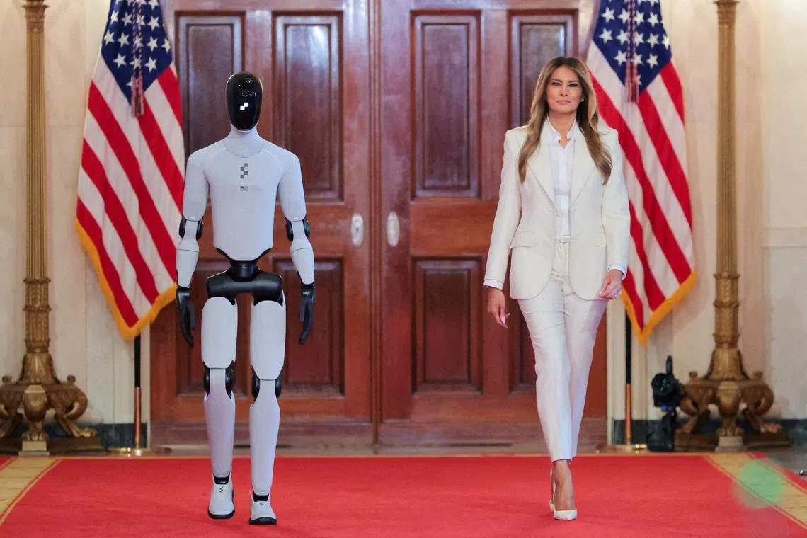 U.S. first lady Melania Trump walks next to a humanoid robot as she hosts a roundtable event on the second day of the inaugural Fostering the Future Together Global Coalition Summit, at the White House in Washington, D.C., U.S., March 25, 2026. REUTERS/Kylie Cooper