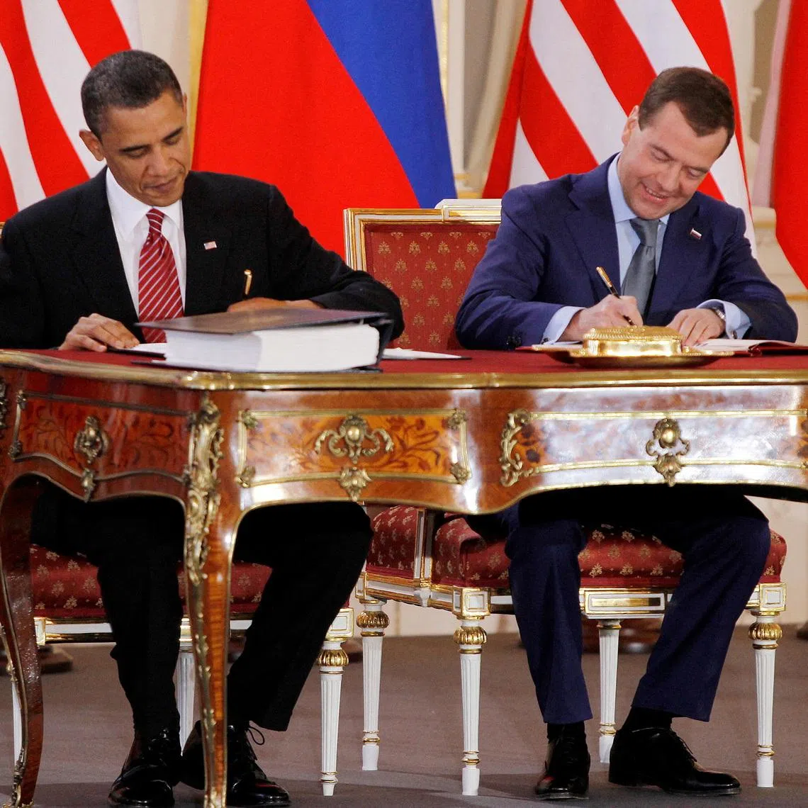 FILE PHOTO: Barack Obama (L) and Dmitry Medvedev, who were then the U.S. and Russian presidents, sign the new Strategic Arms Reduction Treaty (START II) at Prague Castle in Prague April 8, 2010. REUTERS/Jason Reed/File Photo