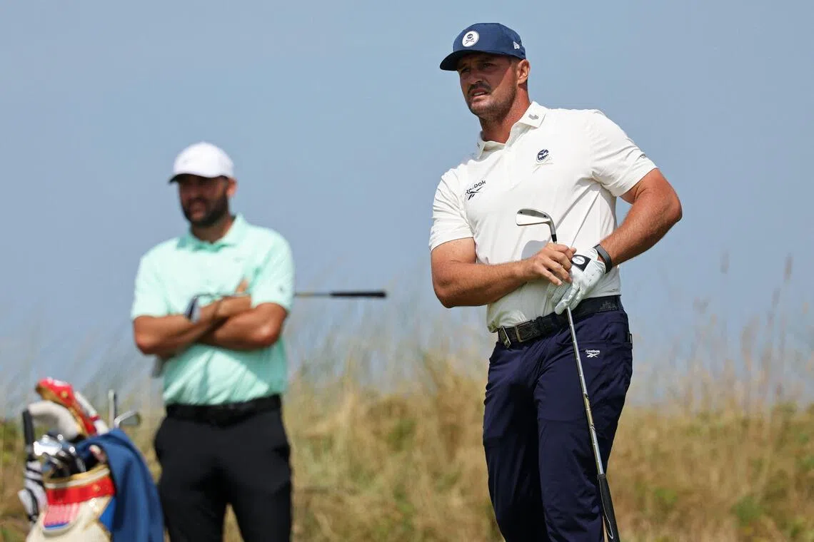 US golfer Bryson DeChambeau (right) watches his iron shot from the 12th tee on day one of the British Open on July 16.