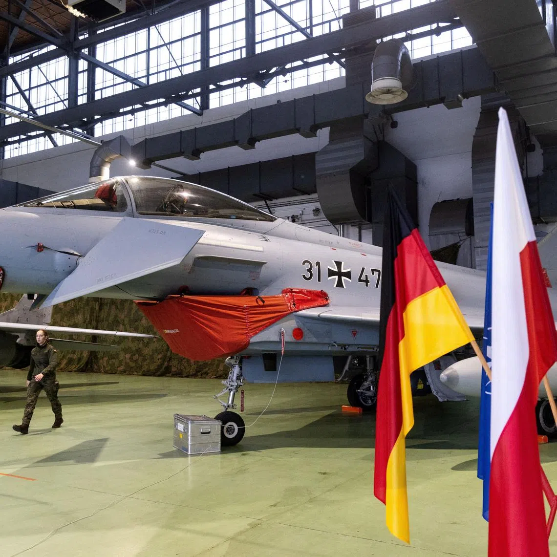 FILE PHOTO: A German Air Force Eurofighter Typhoon fighter jet is displayed in a hangar during the launch of the German contingent’s mission under NATO’s Air Policing operation at the 22nd Tactical Air Base in Malbork, Poland December 10, 2025. REUTERS/Lukasz Glowala/File Photo
