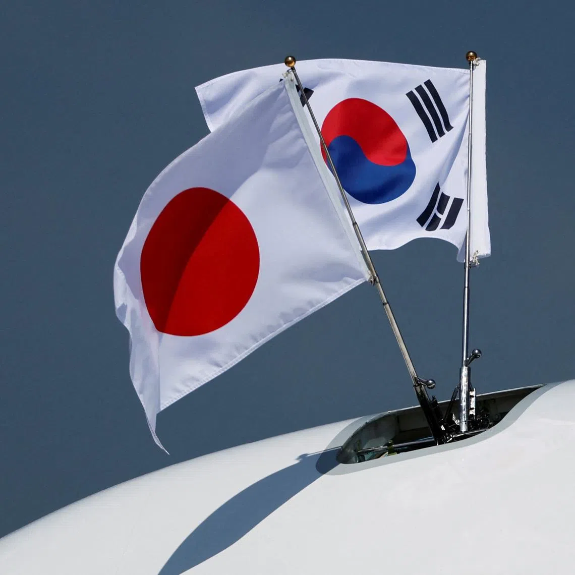 A view of South Korean and Japanese national flags on the airplane carrying South Korea's President Yoon Suk Yeol and his wife Kim Keon-hee, at Tokyo International Airport (Haneda Airport) in Tokyo, Japan March 16, 2023.   REUTERS/Issei Kato