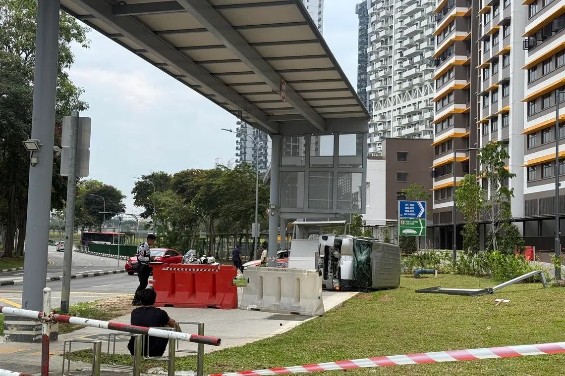 The van can be seen flipped on its side along the pedestrian crossing.
