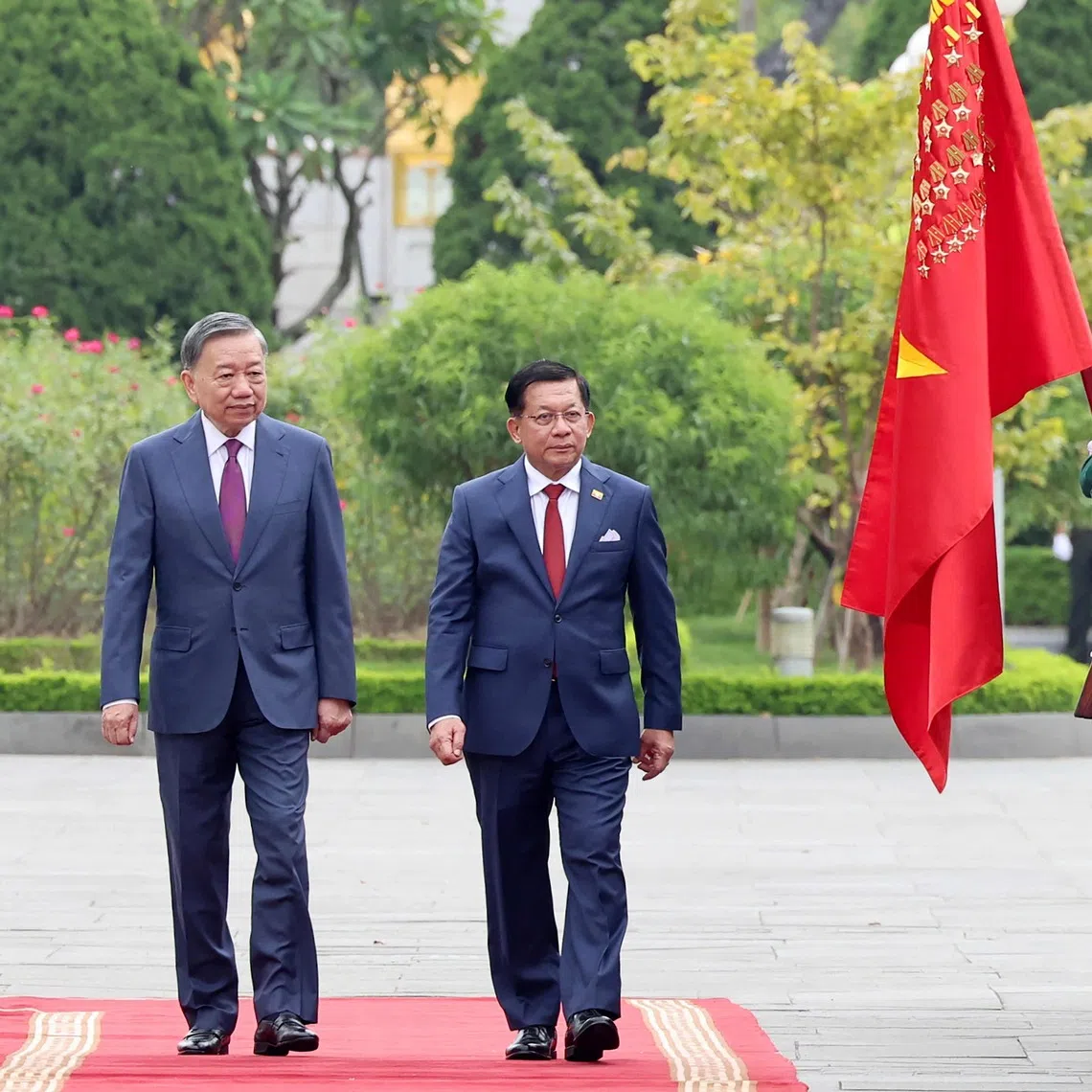 Vietnam’s President To Lam (left) and Myanmar’s President Min Aung Hlaing review the guard of honour during a welcoming ceremony at the National Assembly House in Hanoi on Sept 5.