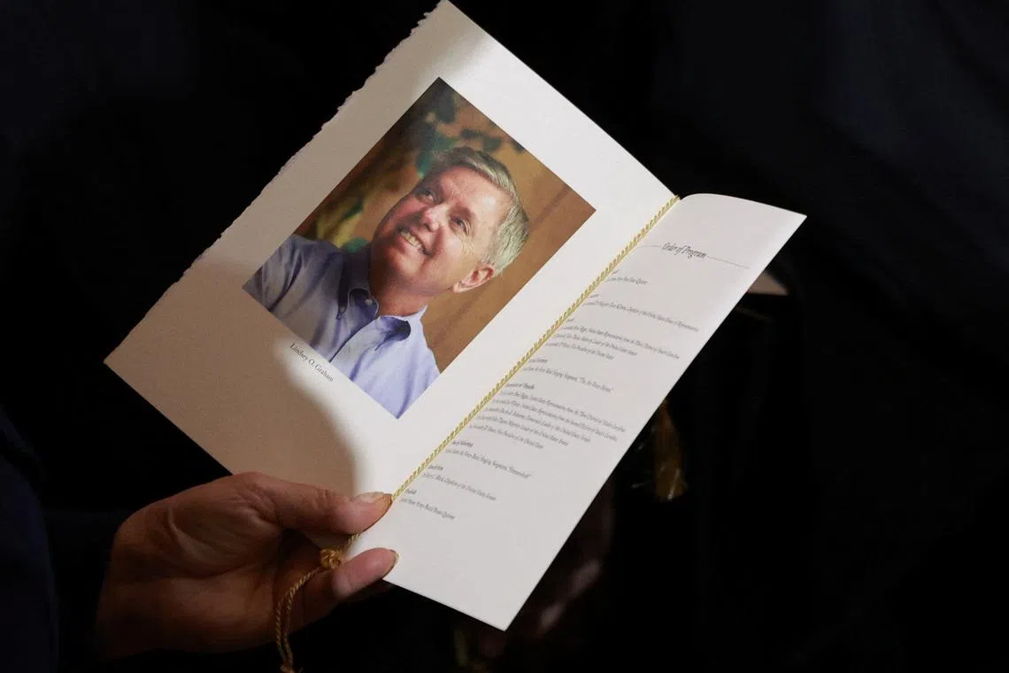 An attendee holds a program during a ceremony for late Republican Senator Lindsey Graham (R-SC) in the rotunda of the US Capitol in Washington, DC, US, on Tuesday, July 28, 2026. Tierney L. Cross/Pool via REUTERS