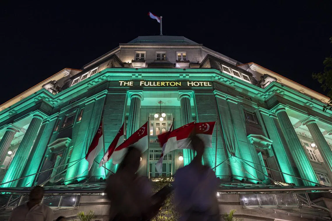 The Fullerton Hotel lit up in green and white on June 26, 2025, as part of the DrugFreeSG Light-Up organised by the Central Narcotics Bureau (CNB). From 7.30pm to midnight, 48 landmarks across Singapore were illuminated in the colours of the Anti-Drug Ribbon to mark the International Day Against Drug Abuse and Illicit Trafficking.