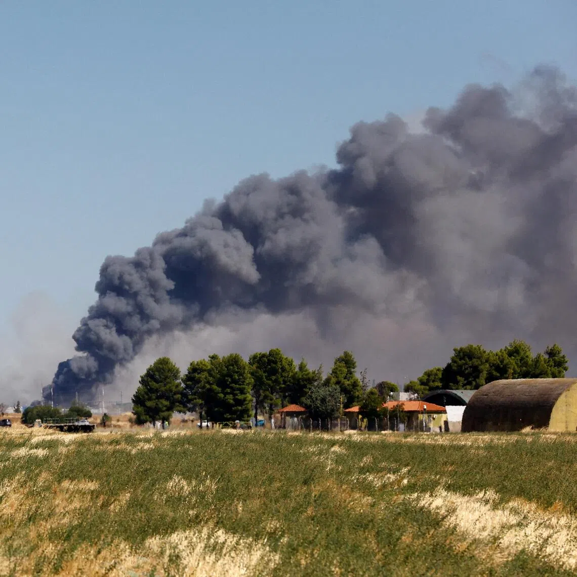 Smoke rises following the crash of a Greek F-4 Phantom fighter jet during the Athens Flying Week air show in Tanagra, Greece, on Sept 5.