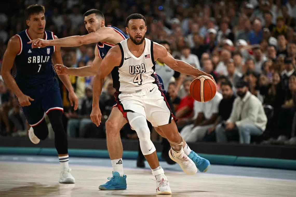 USA's Stephen Curry dribbles the ball in the men's semi-final basketball match against Serbia at the Bercy Arena in Paris.