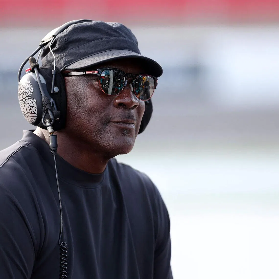 Michael Jordan, NBA Hall of Famer and co-owner of 23XI Racing listening to the race on pit road during the Nascar Cup Series Bank of America ROVAL 400 at Charlotte Motor Speedway on Oct 5, 2025 in Concord, North Carolina. 