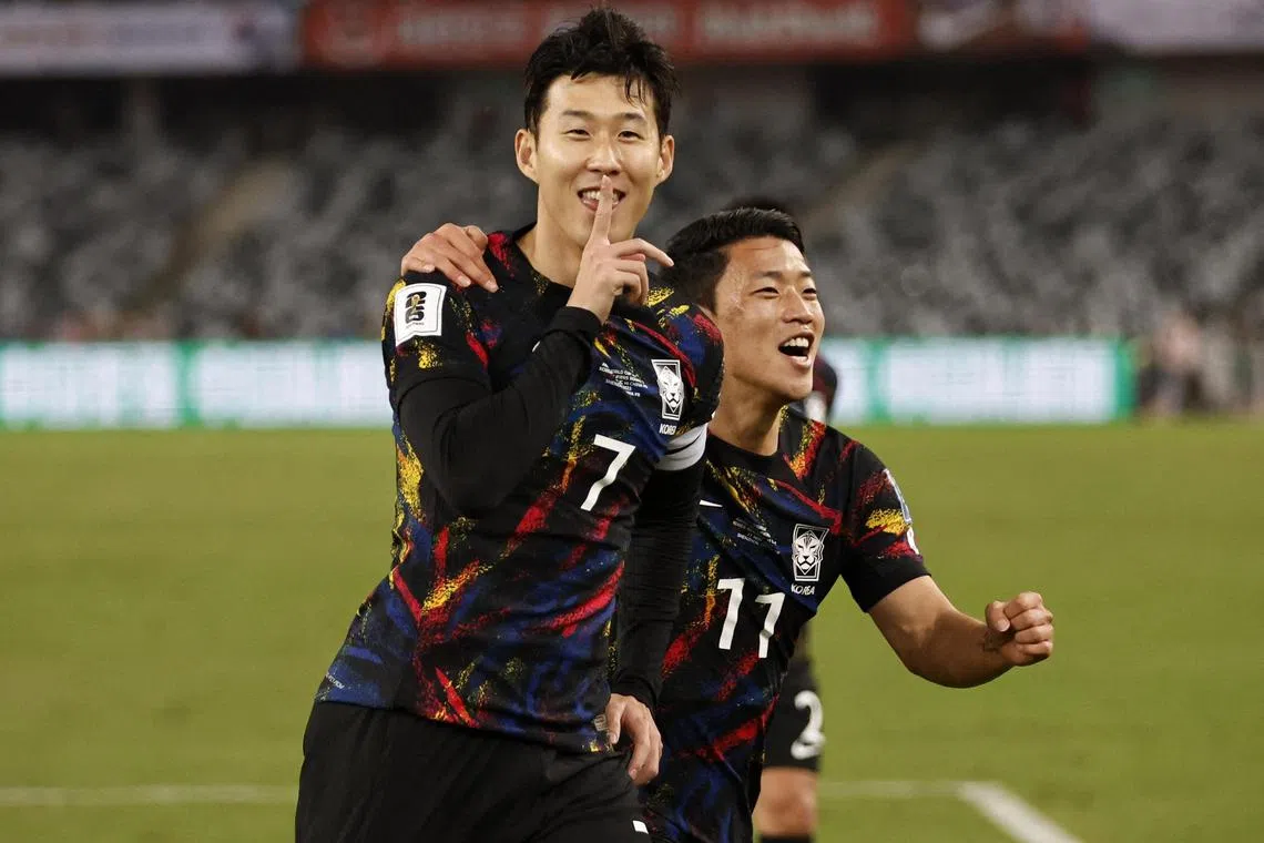 South Korea captain Son Heung-min celebrates with Hwang Hee-chan after scoring the first goal against China.