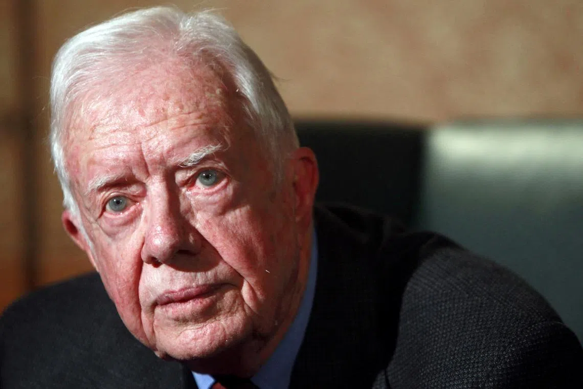 FILE PHOTO: Former U.S. President Jimmy Carter gestures during an interview with Reuters in Cairo January 12, 2012.  REUTERS/Amr Abdallah Dalsh/File Photo