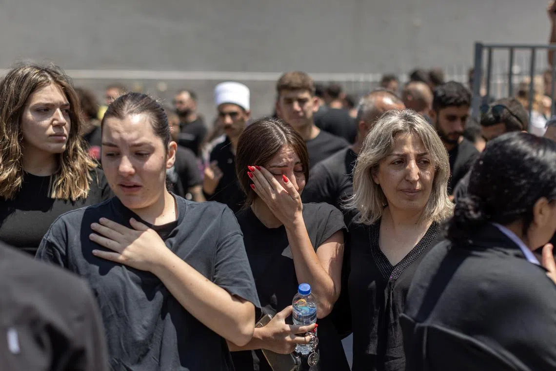 People mourn the deaths of multiple children and teenagers who were killed by a rocket, in the Druze town of Majdal Shams in the Golan Heights, on July 28.