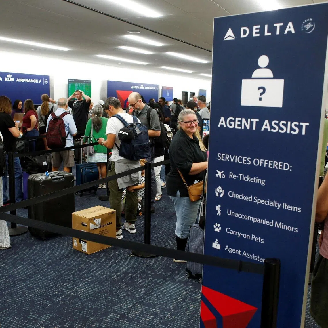Airline passengers wait in line at the Delta, KLM, and Air France ticketing counters  at Tampa International Airport Florida on July 19, 2024, after flights were grounded worldwide.