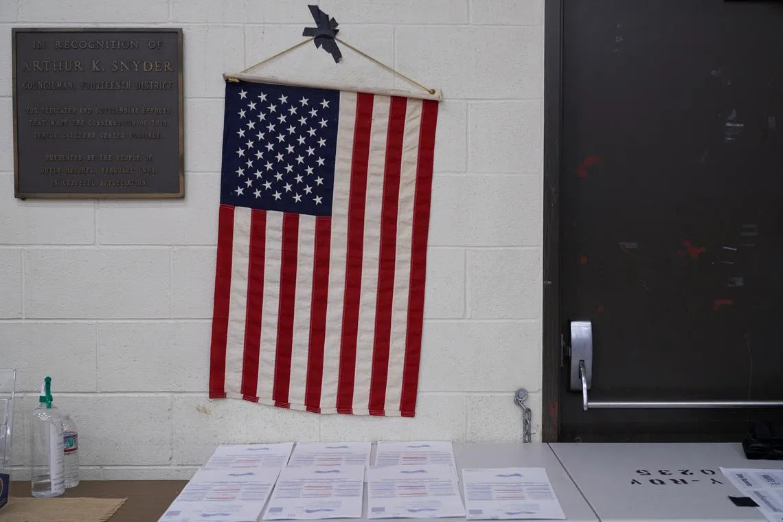 An American flag hangs above ballots in Los Angeles, on Nov 8, 2022.