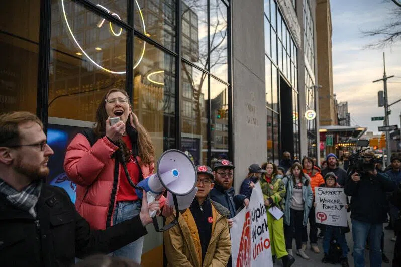Union members protesting in New York against job cuts by Google's parent company Alphabet in 2023. The tech sector continues to shed jobs but AI is not entirely to blame, says the report. 