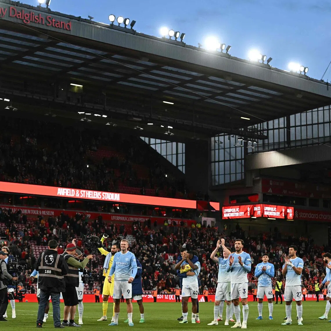 Manchester City players celebrating with fans on the pitch after thumping Liverpool 3-0 in the English Premier League at Anfield in on Oct 11.