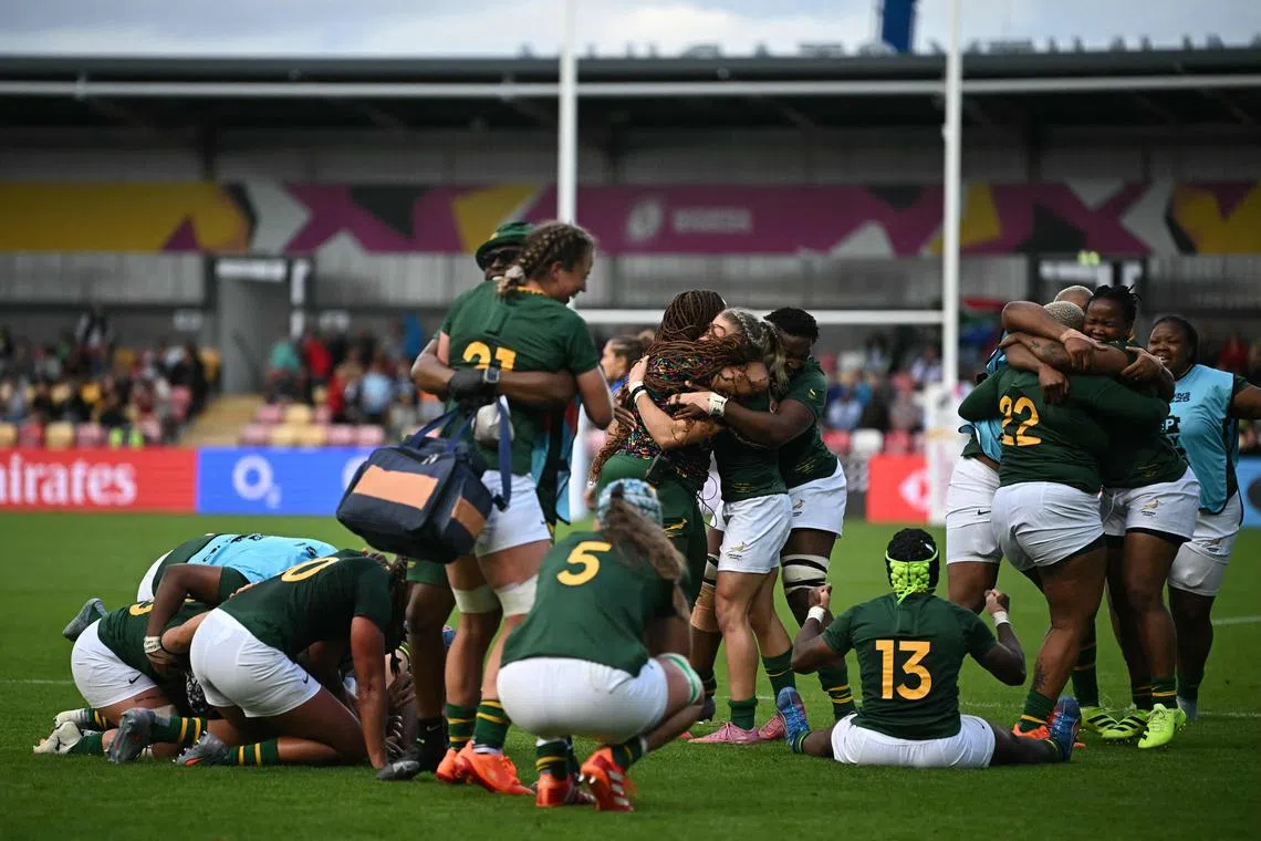South Africa's players celebrate their win on the final whistle in the Women’s Rugby World Cup pool D match between Italy and South Africa at York Community Stadium, York, northern England, on August 31, 2025. (Photo by Paul ELLIS / AFP)