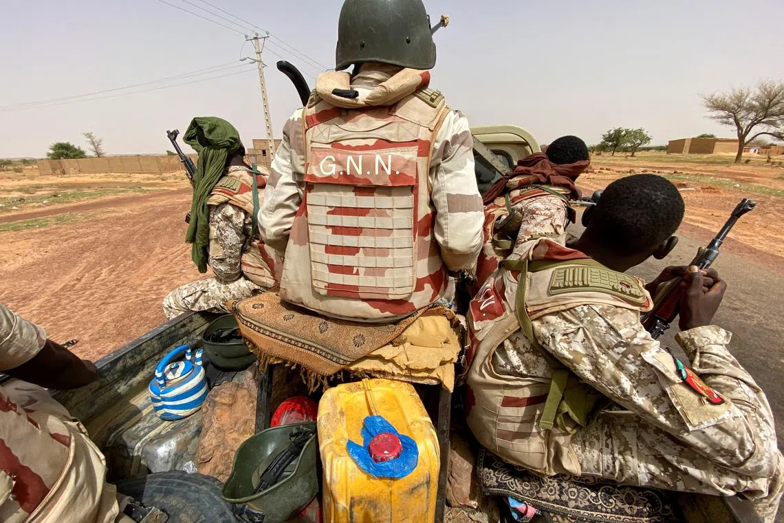 FILE PHOTO: A convoy of Nigerien soldiers patrol outside the town of Ouallam, Niger, July 6, 2021. Picture taken July 6, 2021.  REUTERS/Media Coulibaly/File Photo