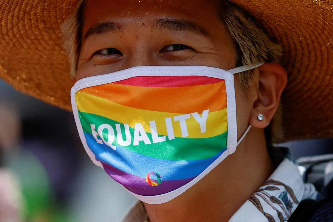FILE PHOTO: A participant wears a mask as they march during the Tokyo Rainbow Pride parade, celebrating advances in LGBTQ rights and calling for marriage equality, in Tokyo, Japan April 23, 2023. REUTERS/Issei Kato/File Photo