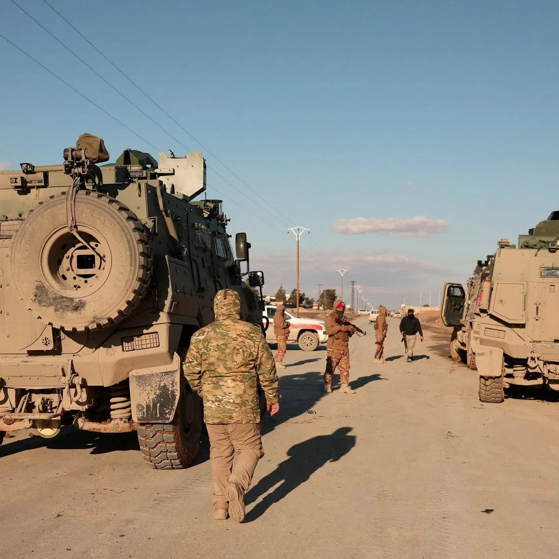 Military members gather near Raqqa prison, where the Syrian army is besieging SDF members after the army took control of the city of Raqqa, Syria January 19, 2026. REUTERS/Mahmoud Hassano