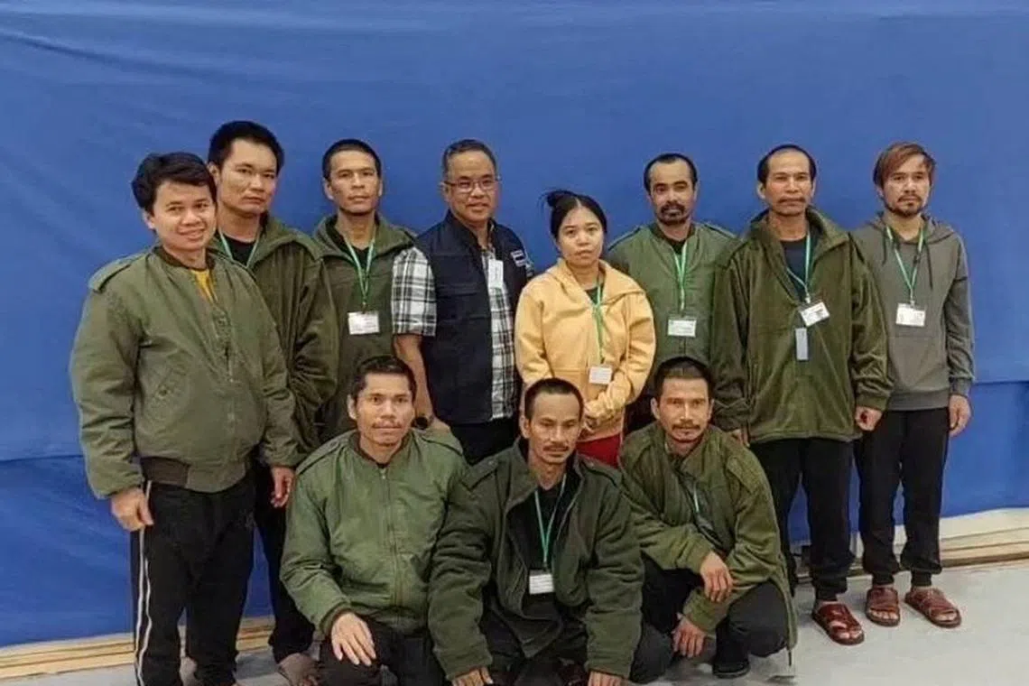 Thai workers taken hostage by Hamas and later released as part of a deal between Israel and Palestinian Islamist group Hamas, pose with a member of Thai mission after a medical checkup, in Tel Aviv, Israel, in this handout image released on November 25, 2023. Ministry Of Foreign Affairs Thailand/Handout via REUTERS