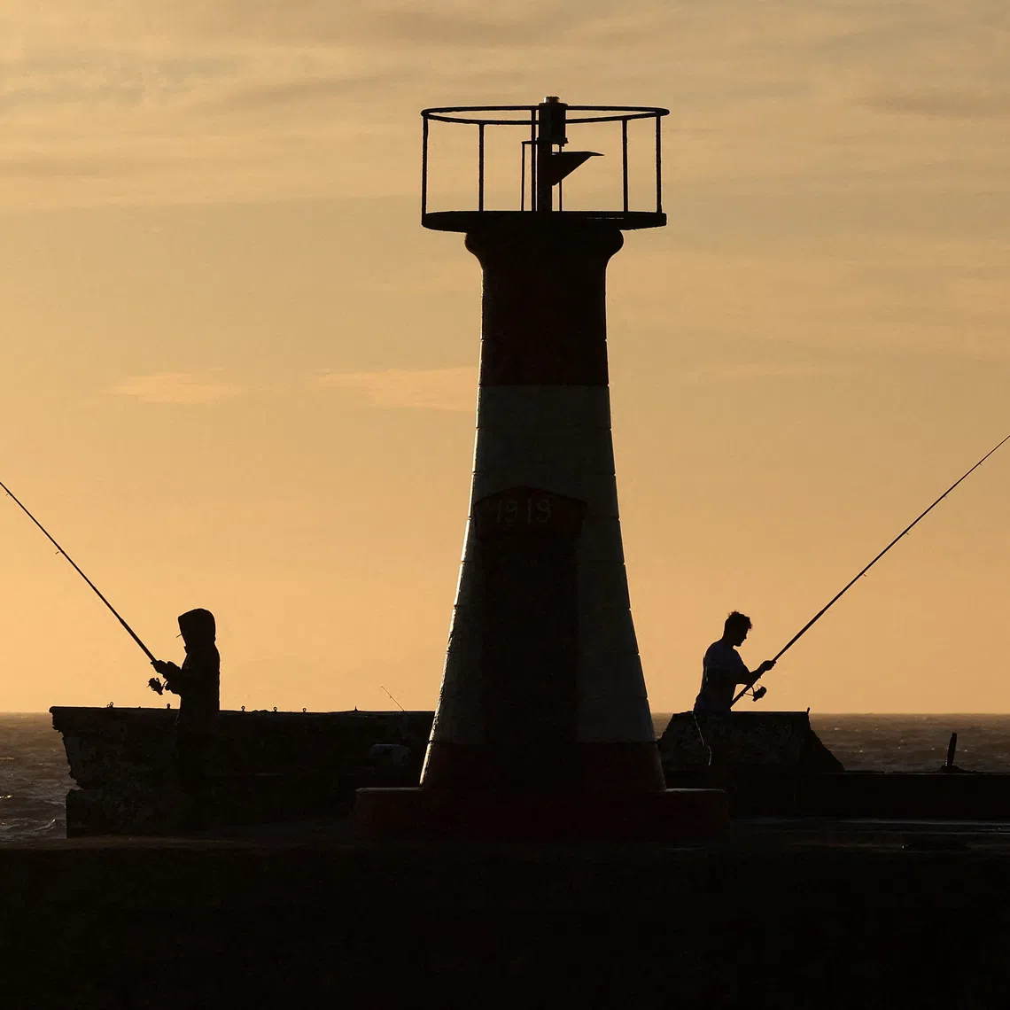 Fishermen at work on the False Bay coastline, in Cape Town, South Africa, on Dec 1, 2025. 