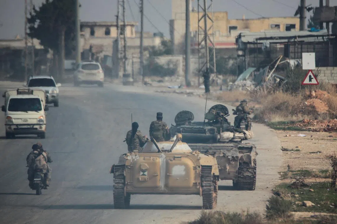 FILE PHOTO: Rebels led by the Islamist militant group Hayat Tahrir al-Sham drive along a street in al-Rashideen, Aleppo province, Syria November 29, 2024. REUTERS/Mahmoud Hasano/File Photo