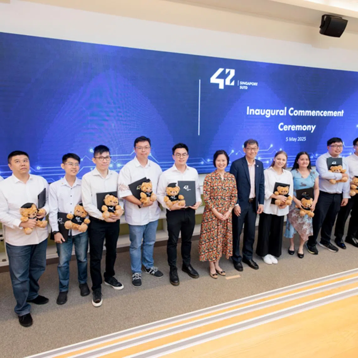 Ms Gan Siow Huang, Minister of State for Foreign Affairs, and Trade and Industry, with the graduands from the pioneering batch of 42 Singapore.