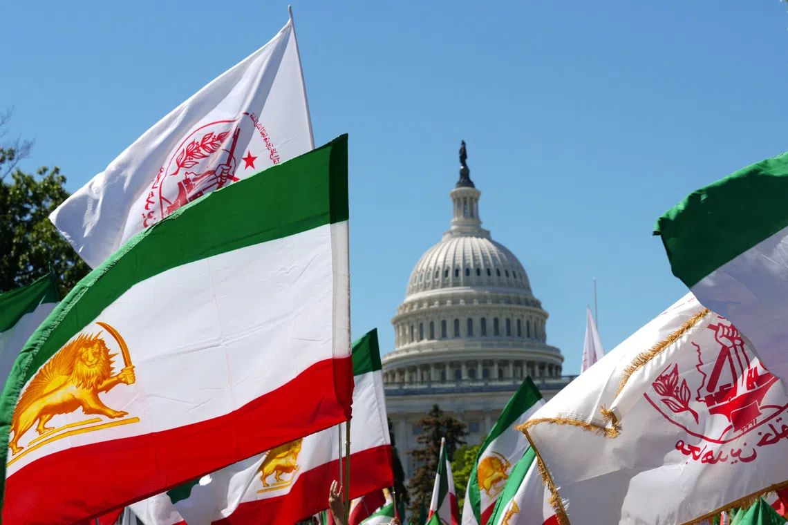 Flags are held by Iranian Americans and supporters of the National Council of Resistance of Iran during a march near the U.S. Capitol in Washington, D.C., U.S., May 16, 2026. REUTERS/Ken Cedeno/File Photo