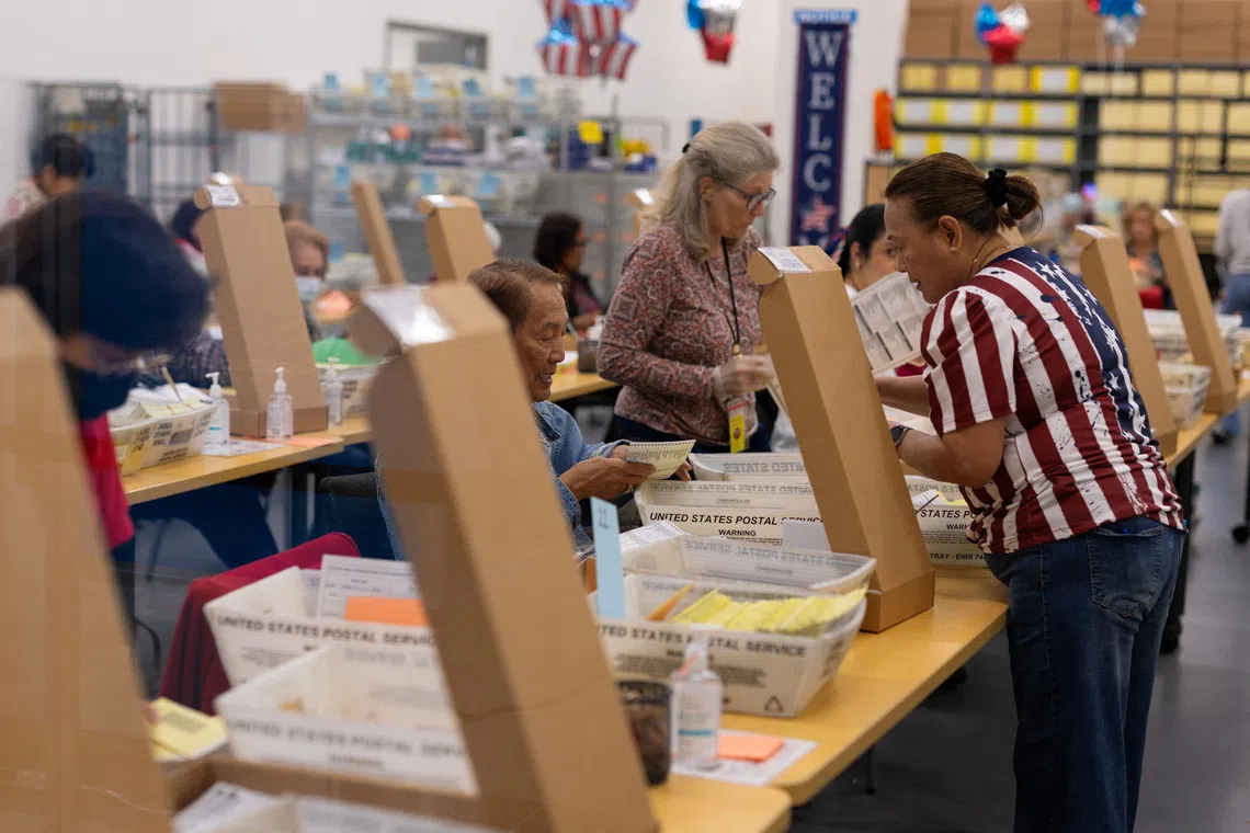 Election workers extract mail-in ballots at the registrar of voters' office during the California primary election in San Diego, California, U.S., June 2, 2026.  REUTERS/Mike Blake
