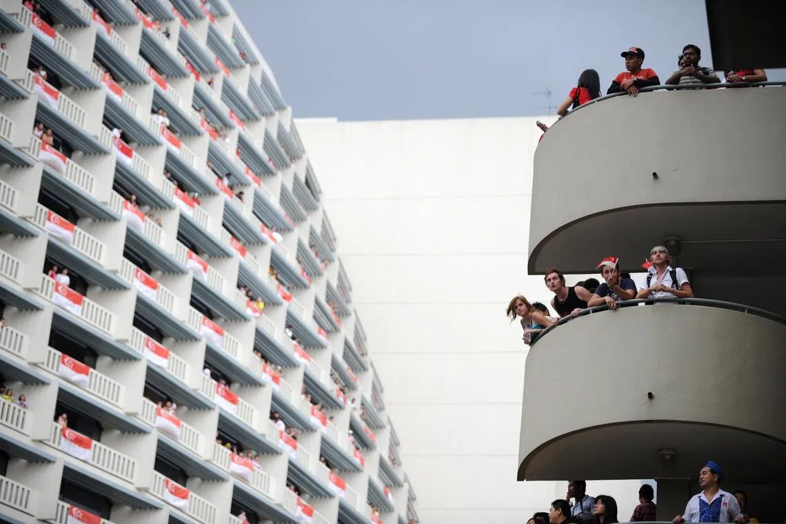 Spectators with no tickets to the 2008 National Day Parade at Marina Bay found a vantage point on a staircase in Marina Square.