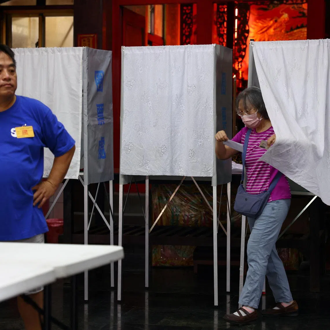 A voter leaves a booth during a recall election, at a polling station in Taipei, Taiwan July 26, 2025. REUTERS/Annabelle Chih