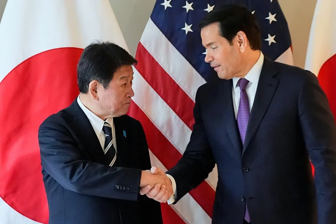 FILE PHOTO: U.S. Secretary of State Marco Rubio shakes hands with Japan's Foreign Minister Toshimitsu Motegi on the sidelines of the Munich Security Conference in Munich, Germany, February 14, 2026.  Alex Brandon/Pool via REUTERS/File Photo