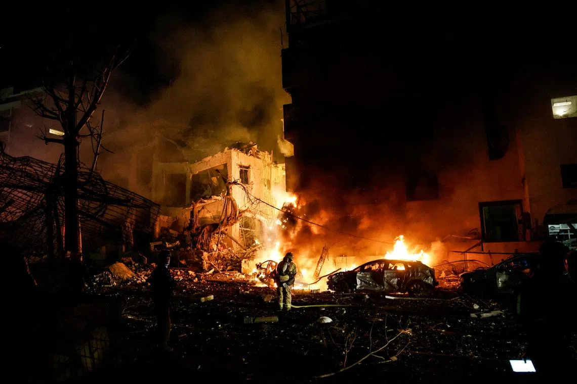 Israeli firefighters working to put out a fire on a car at the site of a projectile impact after Iran launched missiles into Israel, following Israeli and U.S. strikes on Iran, in Tel Aviv, Israel, on Feb 28, 2026. 