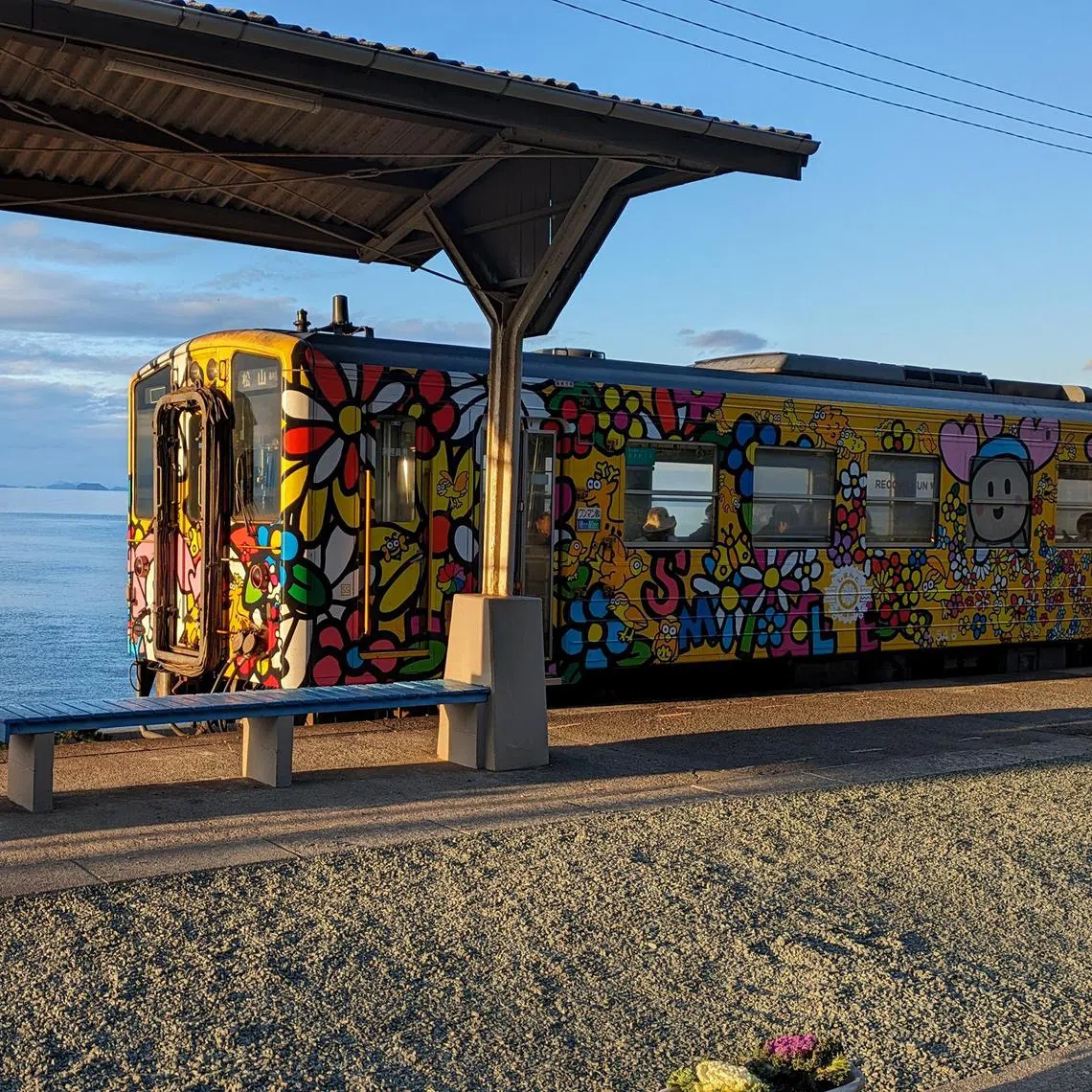 A brightly coloured train leaving Shimonada Station in Shikoku, the smallest of Japan's four main islands.