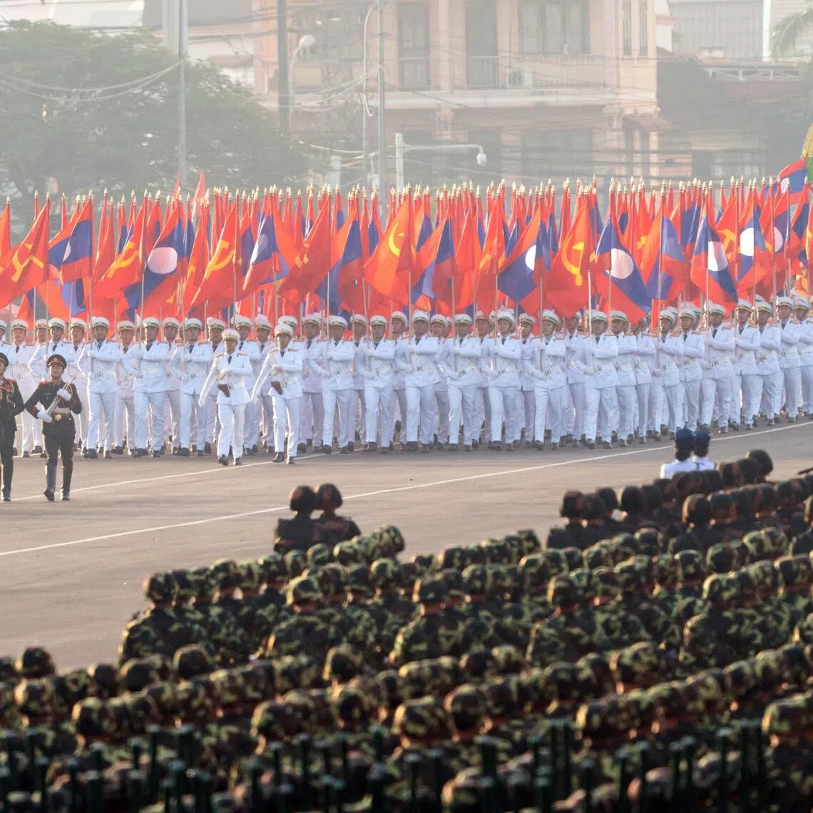 Laos military members taking part in a rehearsal in the run-up to the Dec 2 celebrations of 50 years of communist rule.