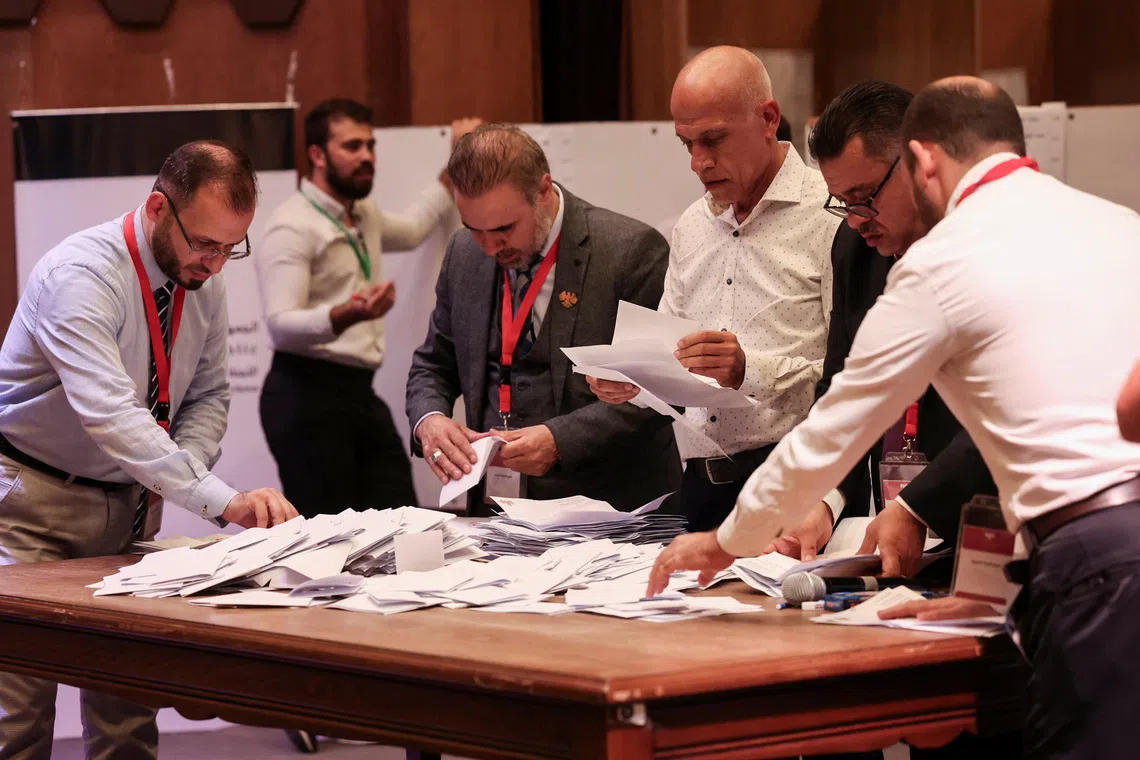 Members of electoral colleges count votes, on the day they vote for candidates of the new Syrian Parliament since Bashar al-Assad's government was toppled, in Aleppo, Syria, October 5, 2025. REUTERS/Mahmoud Hassano