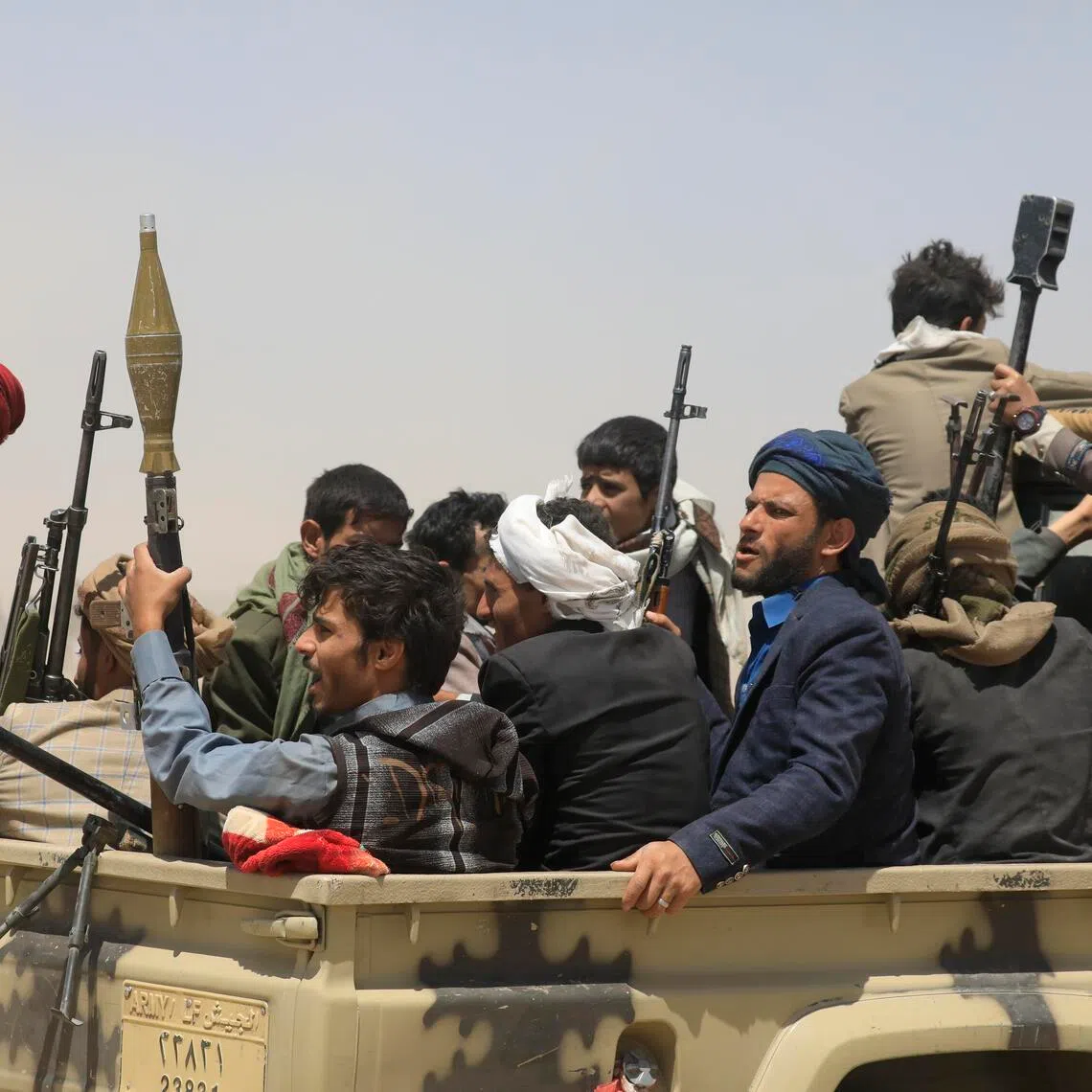 Armed tribesmen ride a vehicle during a gathering to mobilise more fighters in Sanaa, Yemen, on July 2.