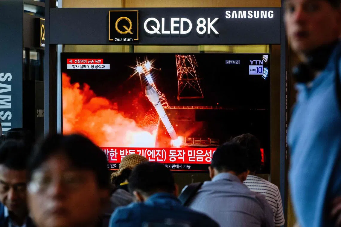 A television showing file footage during a news report at a train station in Seoul on May 28 after North Korea's rocket carrying its reconnaissance satellite exploded minutes after launch.