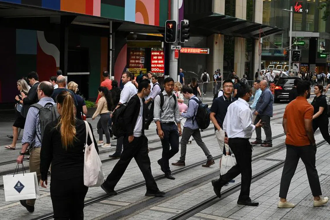 File photo: People cross a street in the city centre following further easing of coronavirus disease (COVID-19) restrictions in Sydney, Australia, December 10, 2020.  REUTERS/Loren Elliott/File photo
